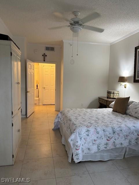 bedroom featuring visible vents, ceiling fan, ornamental molding, a textured ceiling, and light tile patterned flooring