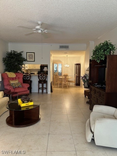 living room with visible vents, ceiling fan, a textured ceiling, and light tile patterned floors