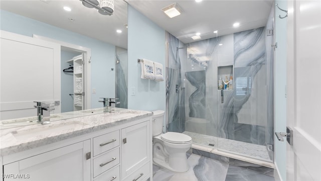 bathroom featuring vanity, toilet, and a shower with door