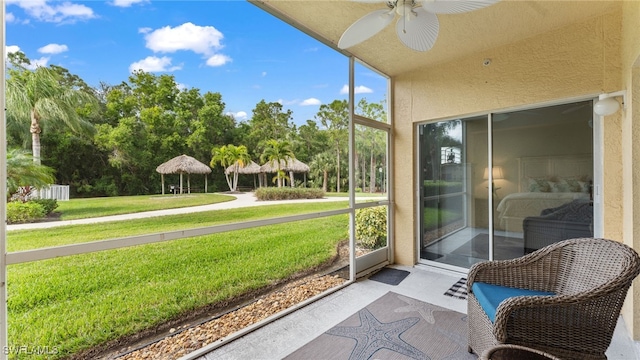 sunroom featuring ceiling fan