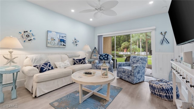 living room with light hardwood / wood-style floors and ceiling fan