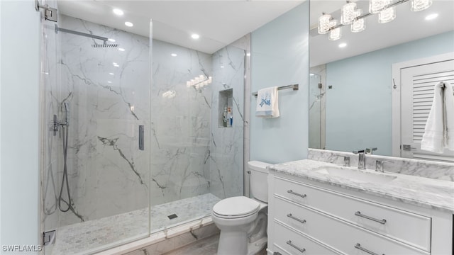 bathroom featuring vanity, toilet, and walk in shower