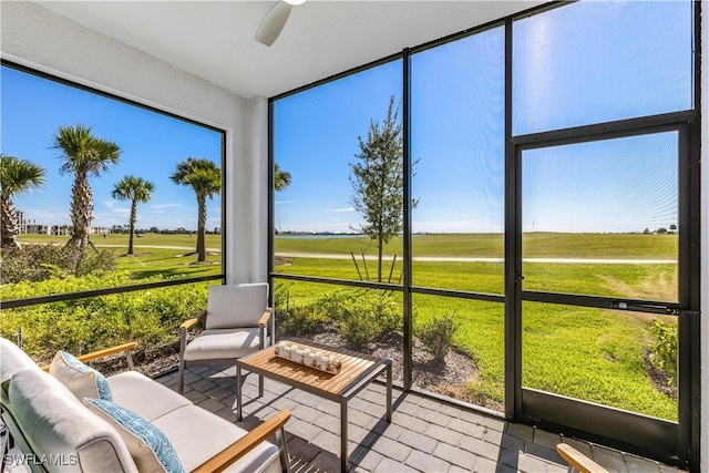 sunroom with ceiling fan and a healthy amount of sunlight