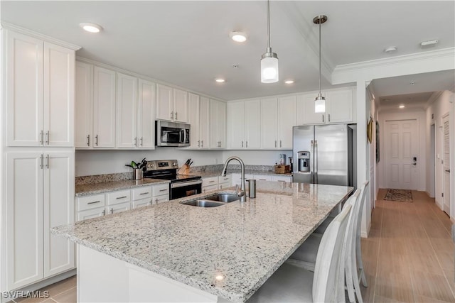 kitchen featuring white cabinetry, an island with sink, and appliances with stainless steel finishes