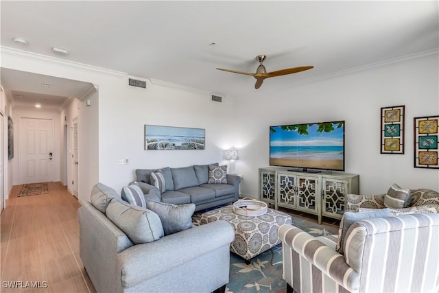 living room featuring ceiling fan and ornamental molding