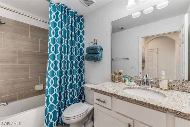 full bathroom featuring vanity, toilet, and shower / bath combo with shower curtain