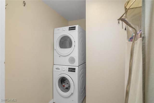 laundry room with stacked washer / dryer