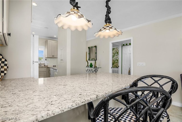 kitchen featuring tasteful backsplash, crown molding, light stone countertops, and light wood-type flooring