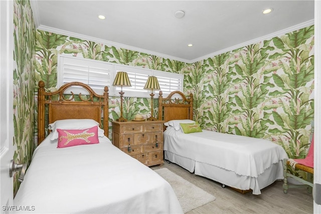 bedroom with light wood-type flooring and crown molding