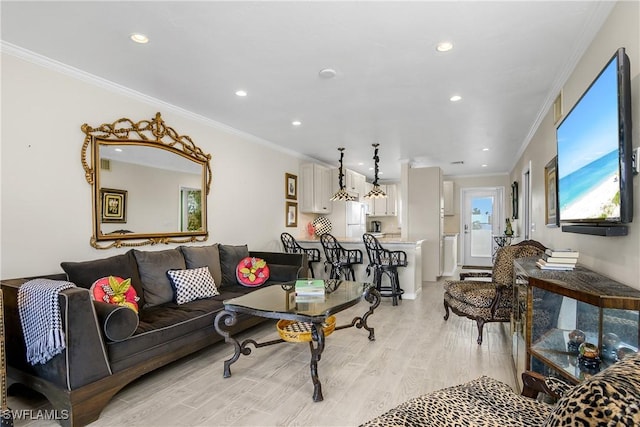 living room featuring light hardwood / wood-style flooring and ornamental molding