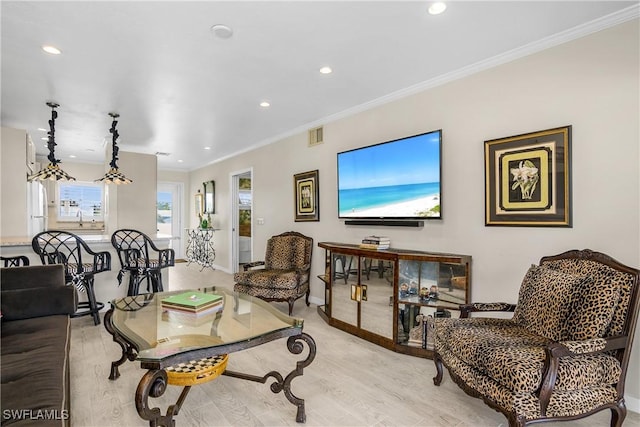 living room featuring crown molding and light hardwood / wood-style flooring