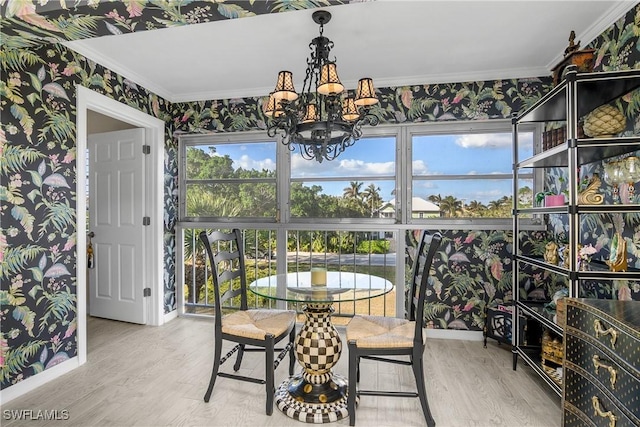 dining room with crown molding, hardwood / wood-style floors, and a chandelier