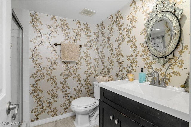 bathroom featuring hardwood / wood-style floors, vanity, and toilet