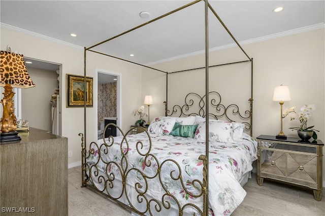 bedroom featuring light wood-type flooring and crown molding