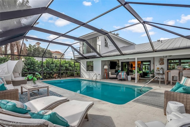 view of swimming pool with an outdoor hangout area, a patio, ceiling fan, and a lanai