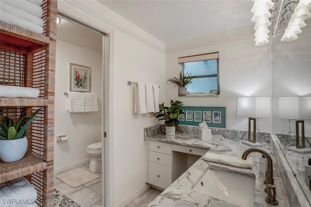 bathroom featuring tile patterned floors, vanity, ornamental molding, and toilet