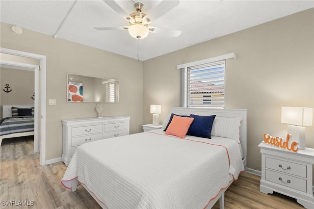 bedroom featuring ceiling fan and light hardwood / wood-style floors