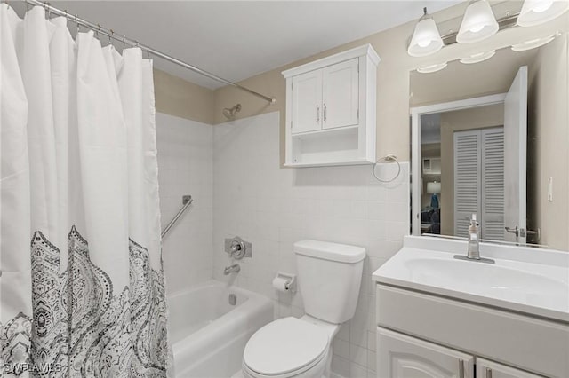 full bathroom with shower / tub combo, vanity, toilet, and tile walls