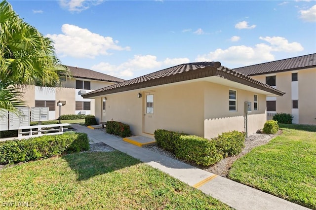 view of property exterior with a lawn