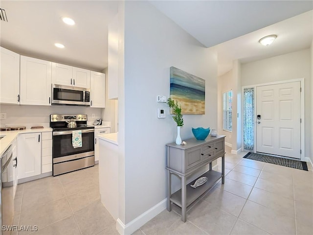 kitchen featuring white cabinets, light tile patterned floors, and stainless steel appliances