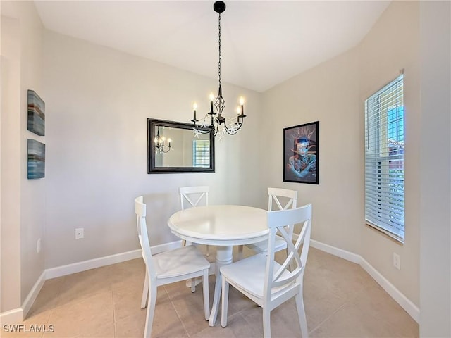 tiled dining space with a healthy amount of sunlight and a chandelier