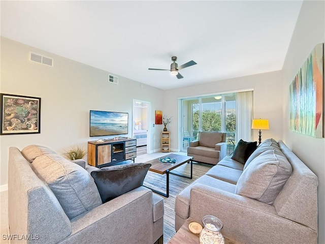 living room featuring ceiling fan and hardwood / wood-style floors