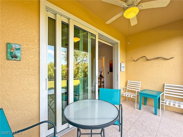 exterior space with ceiling fan and a patio area