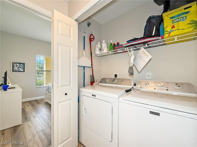 laundry room featuring light hardwood / wood-style floors and washing machine and clothes dryer