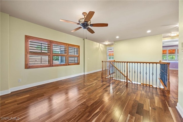 spare room with ceiling fan and dark wood-type flooring