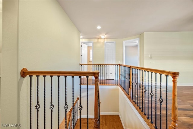 staircase with hardwood / wood-style floors