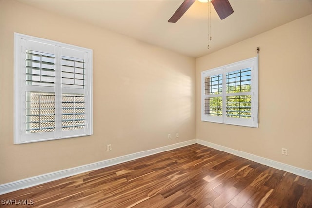 empty room with ceiling fan and dark wood-type flooring