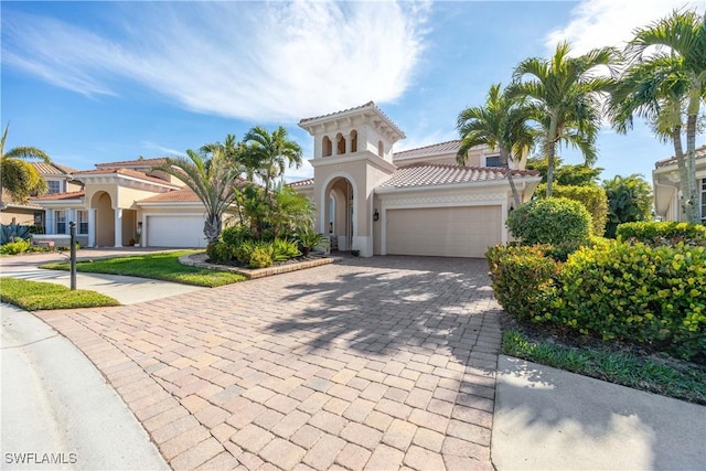 mediterranean / spanish house with a garage