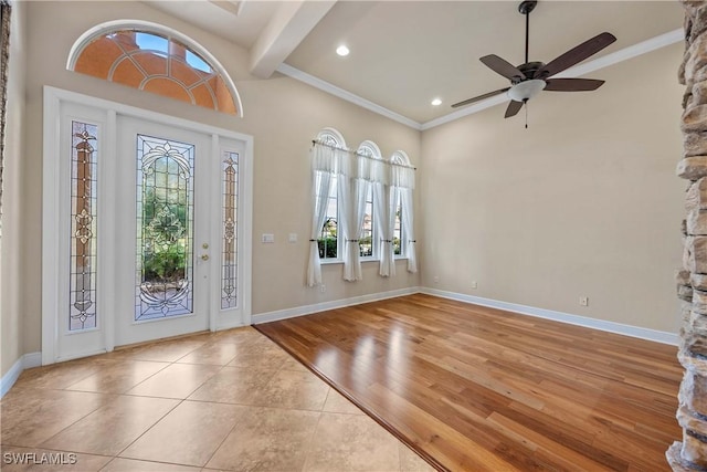 foyer with ornamental molding, light hardwood / wood-style flooring, ceiling fan, and a healthy amount of sunlight