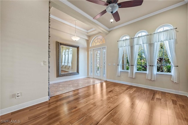 unfurnished room with hardwood / wood-style flooring, a wealth of natural light, and ornamental molding