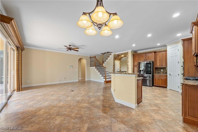 kitchen featuring pendant lighting, plenty of natural light, decorative backsplash, and stainless steel appliances