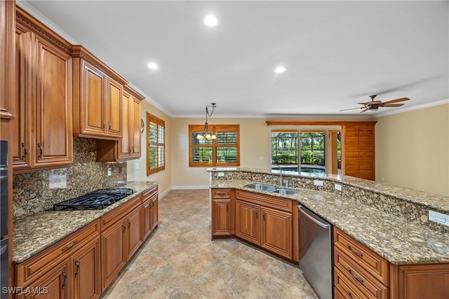 kitchen with ceiling fan with notable chandelier, crown molding, sink, hanging light fixtures, and stainless steel dishwasher