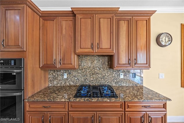 kitchen featuring dark stone countertops, decorative backsplash, black gas cooktop, and stainless steel double oven