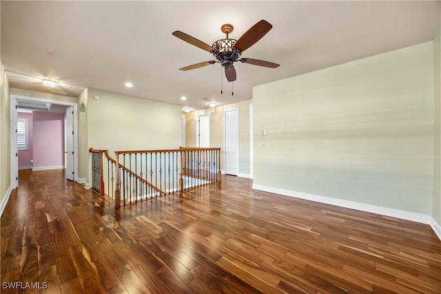 spare room featuring ceiling fan and dark wood-type flooring