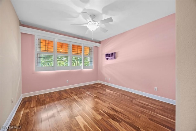 empty room with ceiling fan and hardwood / wood-style flooring