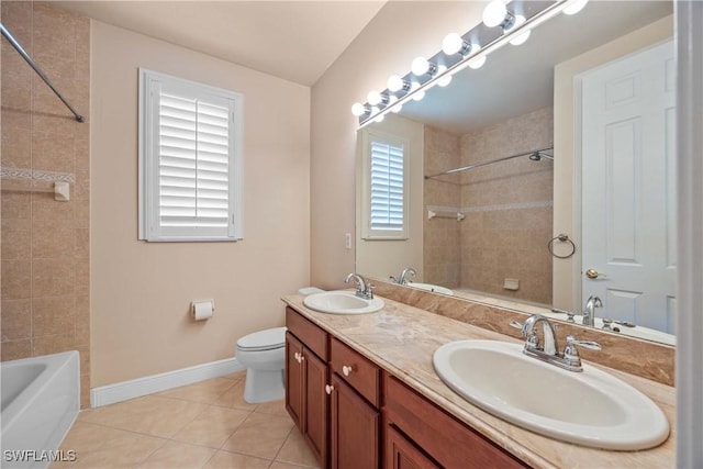 bathroom with a wealth of natural light, tile patterned flooring, vanity, and toilet