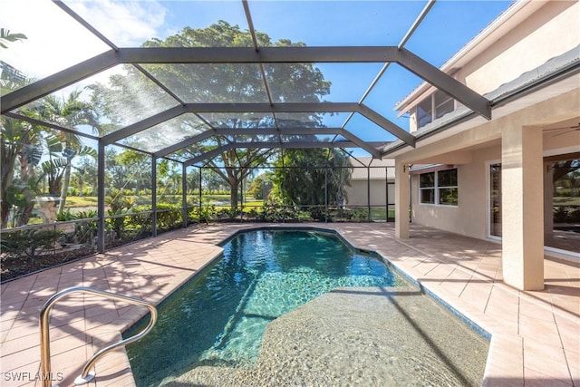 view of swimming pool featuring glass enclosure and a patio area