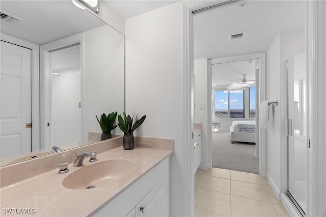 bathroom with tile patterned flooring, vanity, ceiling fan, and walk in shower