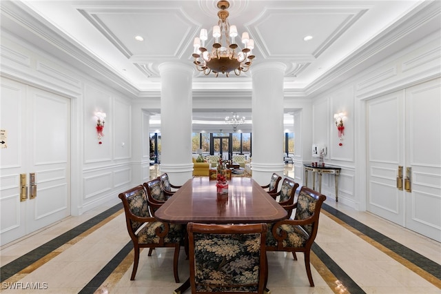 dining room with ornate columns, crown molding, and a chandelier