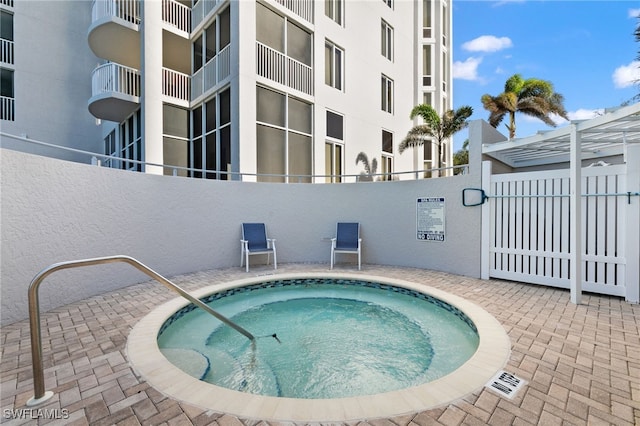 view of swimming pool with a community hot tub