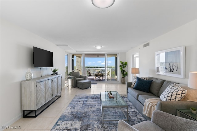 tiled living room featuring floor to ceiling windows and a healthy amount of sunlight