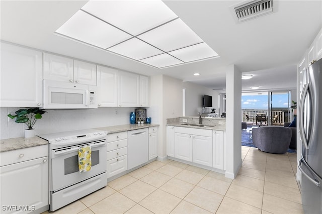 kitchen featuring white cabinets, white appliances, and sink