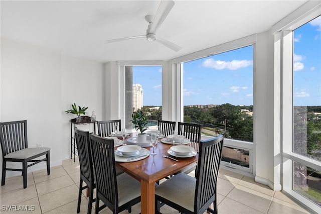 dining area with light tile patterned floors and ceiling fan