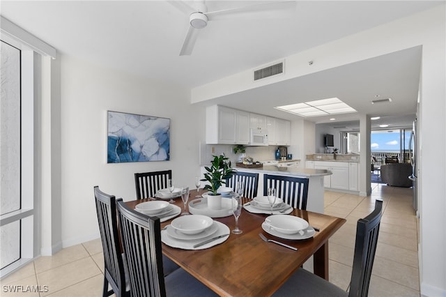 tiled dining area featuring ceiling fan