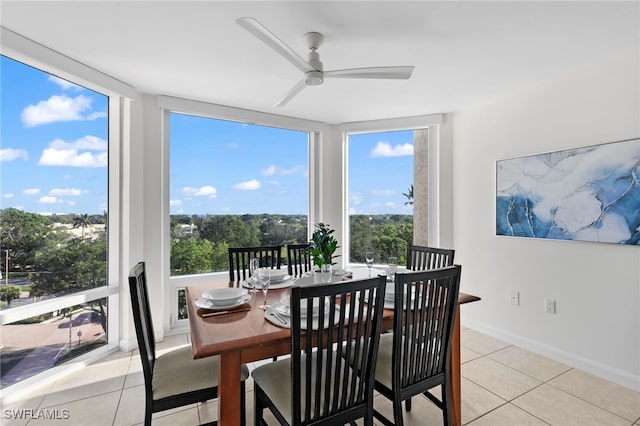 dining area featuring ceiling fan and light tile patterned floors