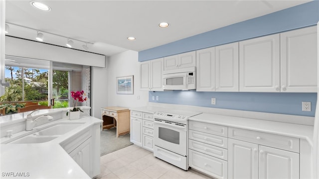 kitchen featuring white cabinetry, sink, and white appliances